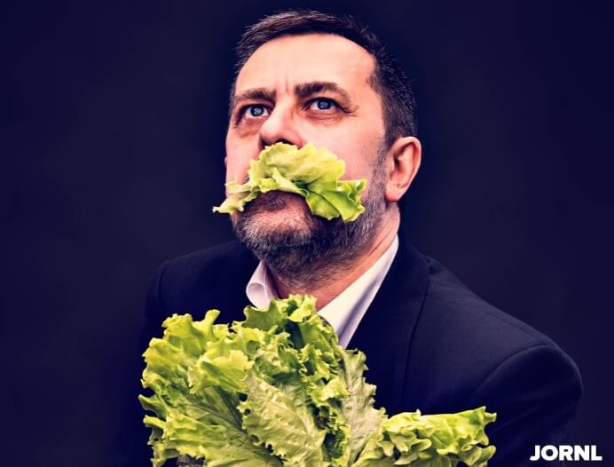 Man holding and eating lettuce