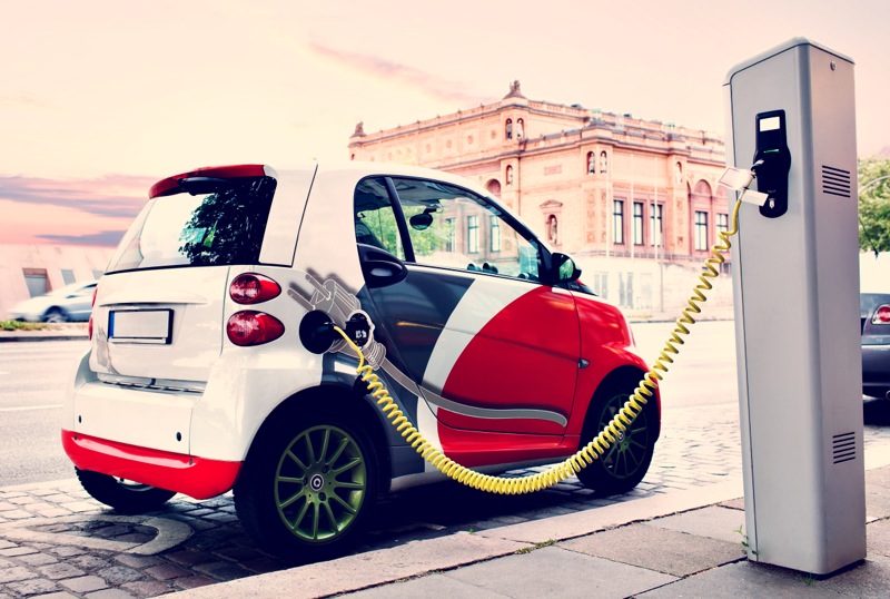 Electro car is charging on the street.